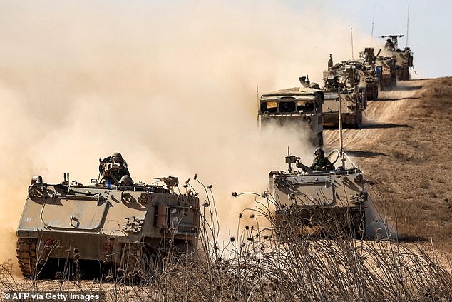 Israeli infantry fighting vehicles (IFVs) are deployed along the border with the Gaza Strip in southern Israel on October 13