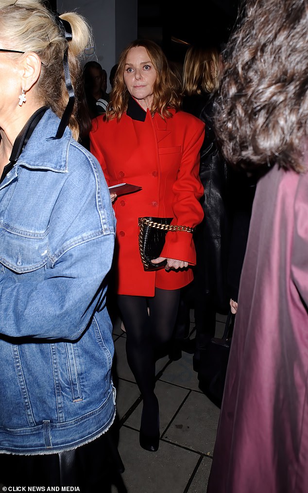 Vision: Stella McCartney looked sensational in a red coat with a black collar and matching black opaque tights as she left the event with the superstar