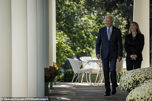 President Joe Biden walks along the column with Becky Chong to the Rose Garden to speak at the White House in Washington, Wednesday, Oct. 11, 2023. Biden began his remarks with the war between Gaza and Israel and turned to protecting consumers from hidden waste charges