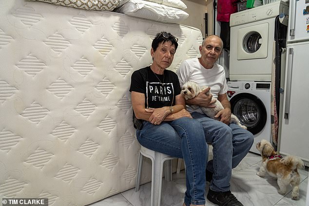 Beverly Jamil and Reuven at home with their dogs.  Despite the horrific atrocities they have suffered nearby and the obvious danger they face, they refuse to move to safer areas in Israel.