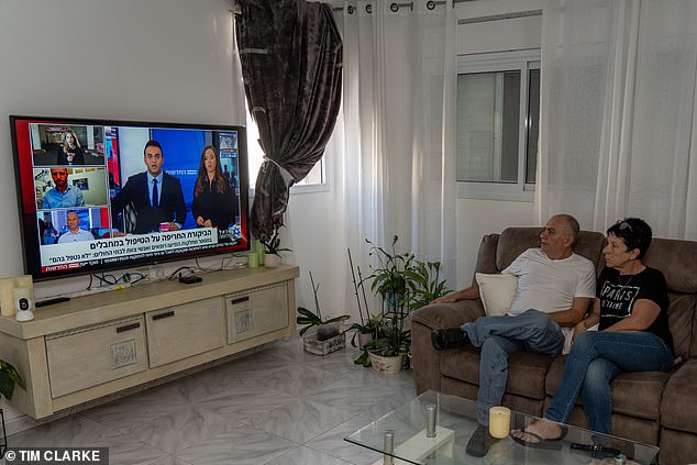 Beverly Jamil and Reuven at home watching the news