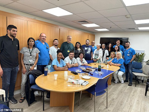 British expatriate gastric surgeon Stephen Malnick with his medical team.  Malnik stands in the middle with a yellow chain