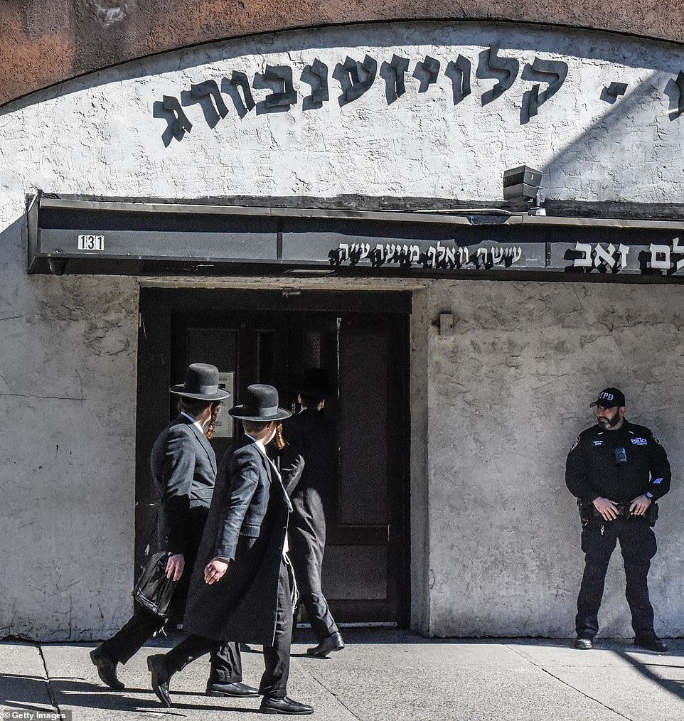 An NYPD officer stationed outside a synagogue in Williamsburg, Brooklyn on Friday the 13th