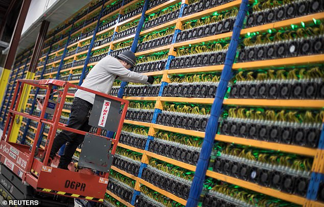 A worker is seen in a file photo at a cryptocurrency mine.  The large computing power and large energy requirements of such enterprises are of concern to defense experts