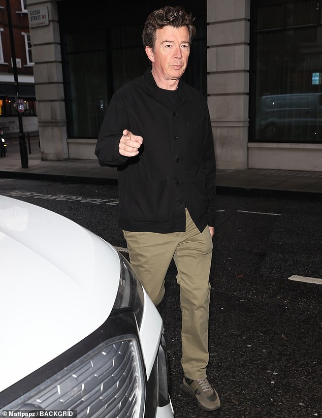 Not alone: ​​Rick Astley, 57, also appeared on Zoe Ball's BBC Radio 2 Breakfast Show on Friday wearing a black top and jacket with khaki trousers and matching trousers