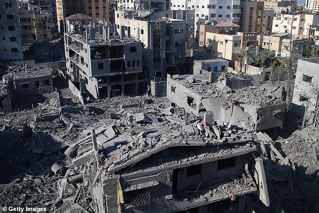 Palestinian civilians inspect damage to their homes caused by Israeli airstrikes on October 13, 2023 in Gaza City, Gaza.  Israel has blockaded Gaza and launched constant retaliatory airstrikes, which have killed at least 1,700 people