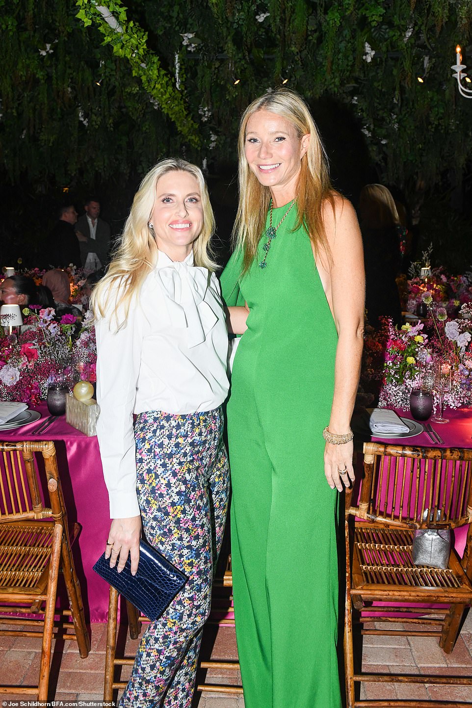 Paltrow is pictured with Sarah Wettenhall, who wore a ruffled white blouse, patterned pants and a navy crocodile-embossed clutch