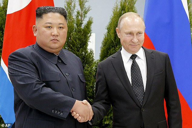 Russian President Vladimir Putin, right, and North Korean leader Kim Jong Un shake hands during a meeting in Vladivostok, Russia on April 25, 2019