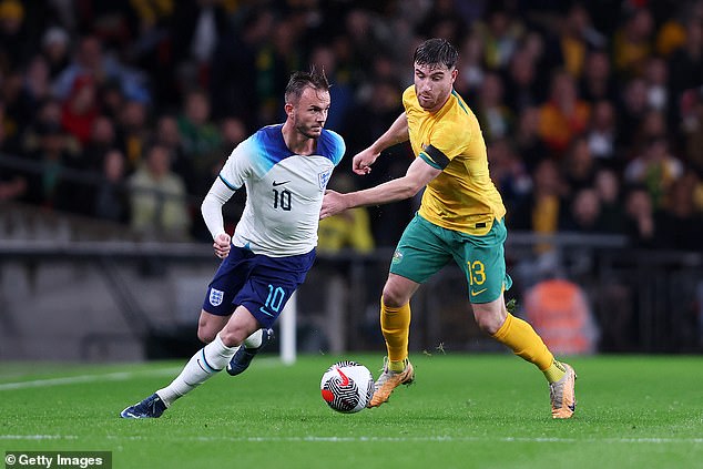 England's James Maddison runs at the ball from Australia's Ryan Strain in a true Davis vs. Goliath match.