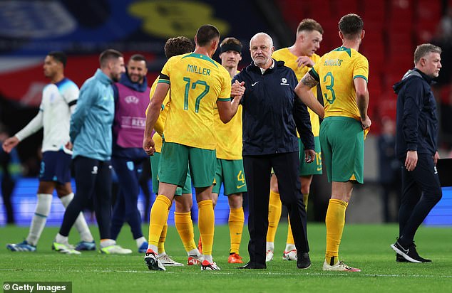 Socceroos coach Graham Arnold hugs his players after their strong performance at Wembley.  He has spoken openly about the lack of funding from the Australian government