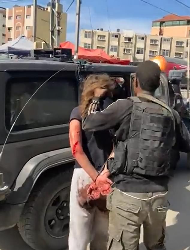 The terrorist is seen forcing the Israeli woman into a car before she is taken to the Gaza Strip