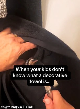 The mum posted a video of herself nailing a black towel to the wall - making sure it couldn't be removed from the shelf