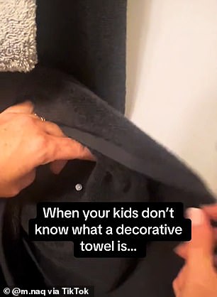 The mum posted a video of herself nailing a black towel to the wall - making sure it couldn't be removed from the shelf