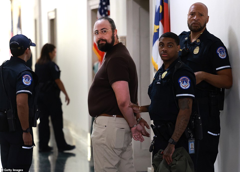 The incident occurred just outside where Republicans are meeting to vote on a new candidate for Speaker of the House.  Capitol Police swooped in to intervene and arrested the protester, identified as Shabd Singh, who got under Santos' skin.  Santos — who is under federal indictment for allegedly embezzling campaign funds and lying to Congress — has also falsely claimed to be Jewish himself in the past.  Pictured: A protester was arrested after confronting members of Congress outside a meeting of the House Republican Caucus.