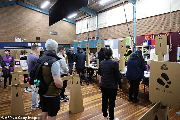 Polls opened across the country (pictured) as Australians voted in the historic referendum, the first in more than 20 years.  In the photo, voters collect ballots at a polling station in St.  Kilda to Melbourne