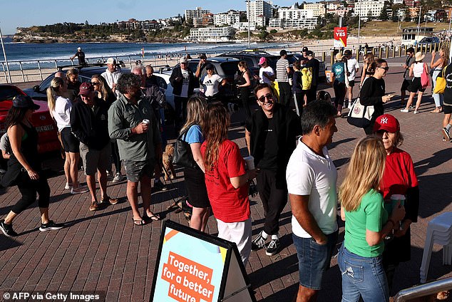 Voters are seen lining Sydney's Bondi Beach (pictured) on Saturday morning to cast their ballots as the Australian Electoral Commission (AEC) warns those who are eligible to vote and who fail to do so risk being fined.