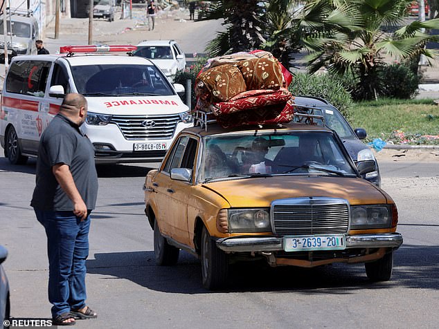 Queues of traffic pictured as they try to leave Gaza City - an evacuation order which the UN says is 'impossible' to fully achieve