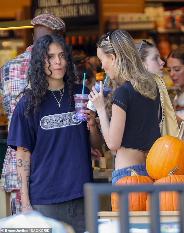 Casual-cool: The rapper and singer opted for casual attire in baggy black jeans, a navy blue Prodigy T-shirt and black trainers on their day out together