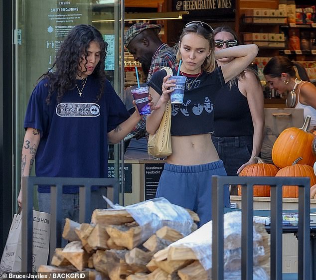 Reveal: The French-American actress flaunts her incredibly toned figure in blue sweatpants and a cropped black Kiss T-shirt