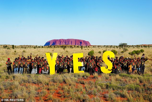 Traditional owners of the land at Uluru are pictured campaigning for Yes