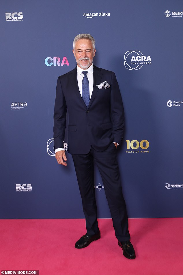 Cameron Dado was every inch the silver fox in a navy suit with powder blue tie and silk pocket square