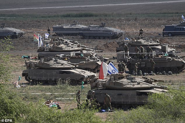 'Merkava' tanks gather today at a gathering point at an undisclosed location along the border with Gaza