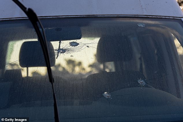 Gabay said the terrorists fired a hail of bullets all over the site, with bullet holes still visible in the windshield of a car pictured on October 13.