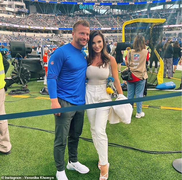 The high-profile couple pose together for a photo at SoFi Stadium, where the Rams play football