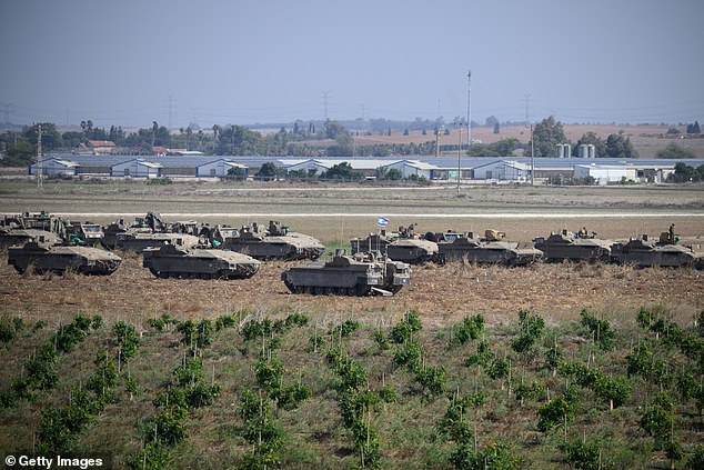 Israeli heavy armored vehicles and tanks marched together at Sderot, Israel, near the border with Gaza