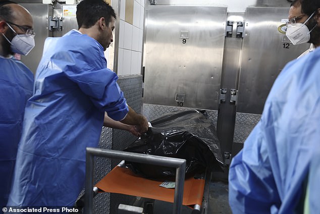 Forensic expert marks a body bag of an Israeli killed by Hamas militants at the National Center for Forensic Medicine in Tel Aviv on Monday