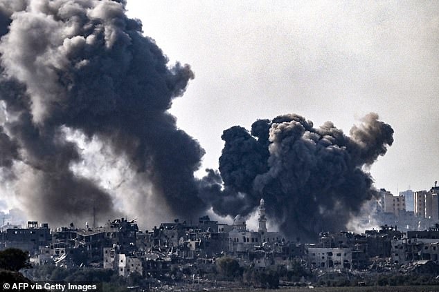 A photo taken from Sderot shows plumes of smoke rising over buildings during an Israeli attack on the northern Gaza Strip on Saturday, as Israel shells Gaza in preparation for a land invasion