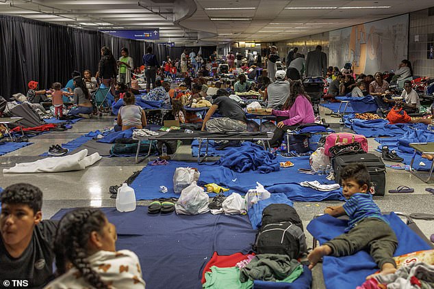 The Windy City is struggling with more than 11,000 migrants in shelters and 4,000 staying in police stations and O'Hare International Airport (photo)