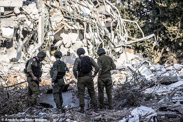 Israeli soldiers patrol the area as traces of clashes between Israeli and Palestinian forces can be seen in Be'eri on October 14.