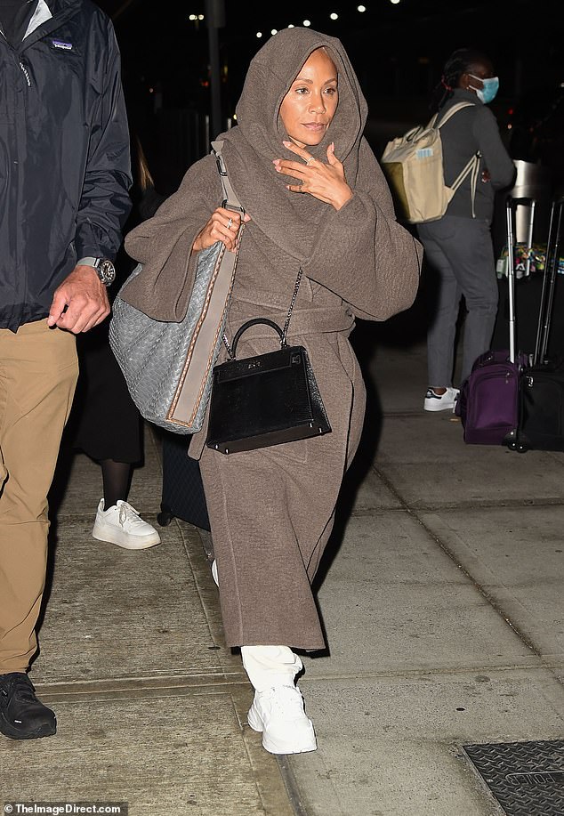 Jada, is that you: The Set It Off starlet nearly got swallowed up by her airport look as she landed at JFK earlier on Monday morning, keeping herself warm in brown overalls and a matching skirt