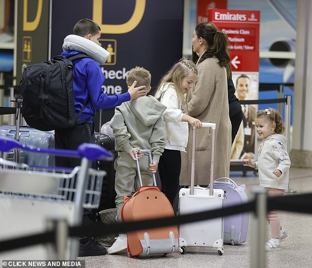 Busy: Despite a teaser detailing explosive revelations about the biggest VAG war in history, Rebecca showed no signs of anticipation at the airport departure terminal