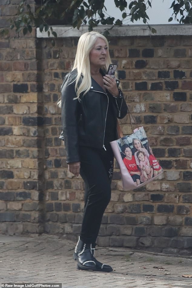 On the move: Vanessa carried a cute bag with a picture of her granddaughter and looked like she was chatting on the phone or recording a voice memo