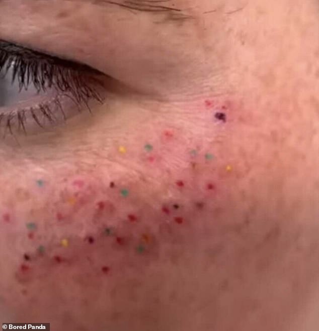 This woman proudly showed off a facial tattoo of what appears to be multi-colored freckles on her cheeks