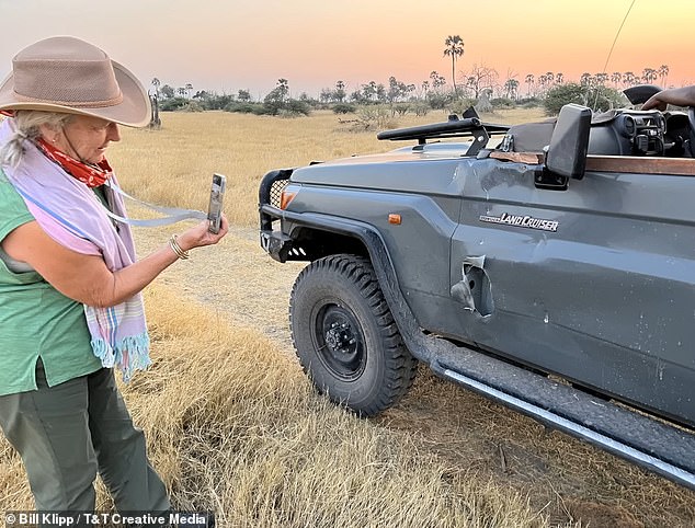 Linda Klipp documents the damage to the safari vehicle after the surprise attack