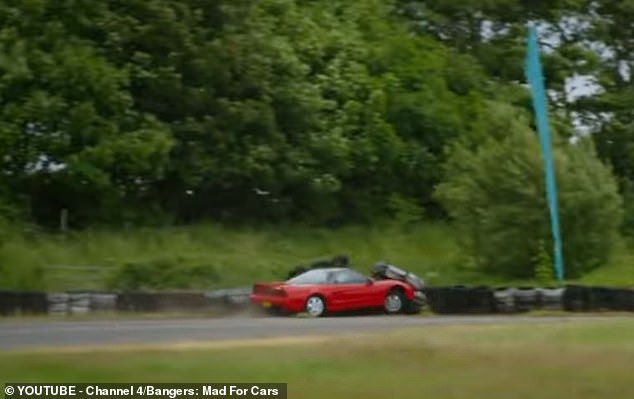 The clip then shows the artist in the valuable Honda supercar crashing into tires in front of obstacles along the side of the track