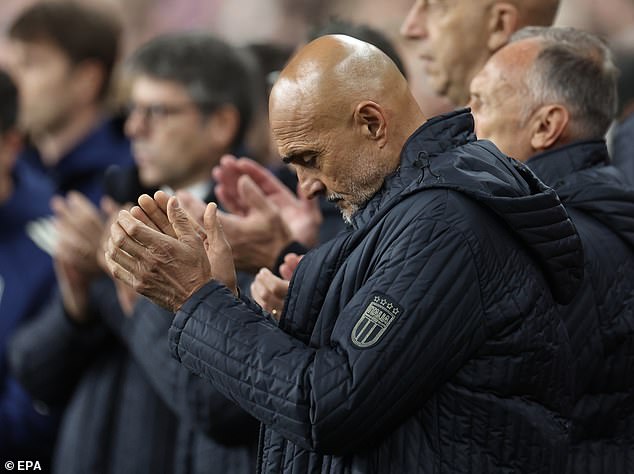 Italian head coach Luciano Spalletti observed the moment of respect with his coaching staff in the dugout