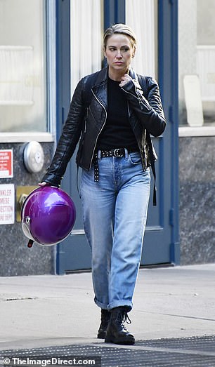 Robach, 50, dressed for the role, opting for a biker-chic look in a black leather jacket, jeans, studded belt and combat boots