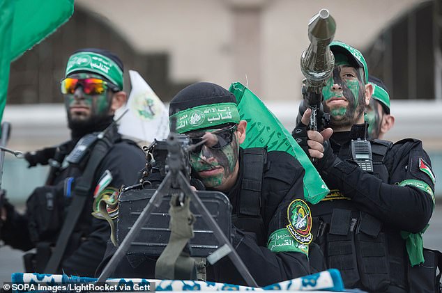 Armed members of the Izz al-Din al-Qassam Brigades – the military wing of Hamas – take part in a march in the southern Gaza Strip in December 2022