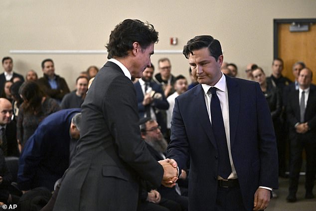 Canadian Prime Minister Justin Trudeau shakes hands with Conservative Leader Pierre Poilievre