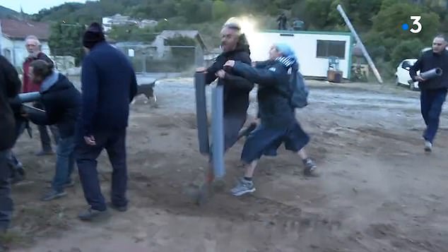 The protester was carrying two large cylinders in each hand as he tried to run away from the nun