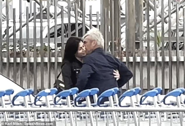 Up close: The actor, 63, and his actress girlfriend, 43, didn't hold back as they locked horns outside the airport in a passionate display of public affection