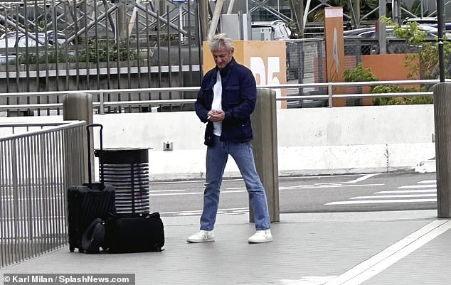 Waiting: The Hollywood star was seen waiting for Olga to pick him up outside the airport after landing in the European country