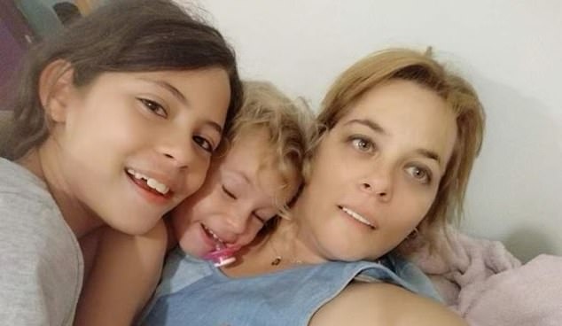 Pictured: Mother Mayaan Zin, 50, panics as her two daughters Dafna, 15 (left) and youngest daughter, Ella, 8, were taken hostage by Hamas