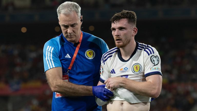 Andy Robertson leaves the field with an injury during Scotland's match against Spain