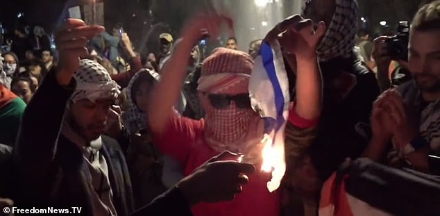 Several pro-Palestinian demonstrators sang "Allahu Akbar!" as they burned the Jewish state's Star of David flag