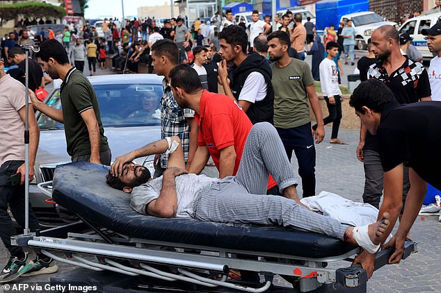 A Palestinian man injured in an Israeli airstrike is driven to Nasser Hospital in Khan Yunis in the southern Gaza Strip on Tuesday